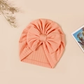 Close-up of soft peach baby beanie featuring rib-knit texture and large bow detail - 17.5x17 cm / Light Orange (#5)