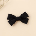 Close-up of black lace bow hair clip showing intricate hollow embroidery and texture - 8.5x5cm / Black