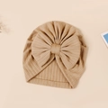 Detail of baby ribbed knit turban hat with large bow in a warm beige solid color - 17.5x17 cm / Nude