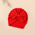 Detailed close-up of a red ribbed baby turban hat with a large bow and elastic texture - 17.5x17 cm / Red