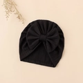 Detailed view of black ribbed knit baby turban hat featuring a large decorative bow tie - 17.5x17 cm / Black