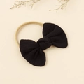 Detalle de un lazo de tela negra en una diadema de nailon beige para bebés y niñas - Negro