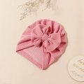 Detail of pink striped baby turban hat with bow knot and texture on wooden background - Dusty Pink