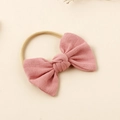 Detailed view of pink fabric bow on elastic nylon headband for babies and kids - Dusty Pink