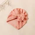 Close-up of pink and white striped baby turban hat with a large decorative soft bow - Light Orange