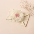 Detail of baby nylon headband with knit texture, mesh flower and satin ribbon bow - Beige