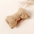 Close-up of beige waffle knit baby headband featuring a soft ribbed bow texture - 16x8.5cm / Khaki