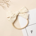 Détail du bandeau bébé en velours côtelé crème avec paillettes dorées et nylon élastique - 9.5*6cm / Blanc Cassé