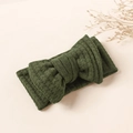 Detailed shot of dark green waffle texture fabric and a large bow on child headband - Dark Green