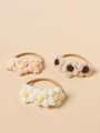 Dettaglio di fasce per capelli con fiori in maglia fatti a mano in rosa e beige - Colore Casuale