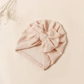 Striped baby turban hat with bow in light peach pink and beige ribbed knit fabric - Apricot