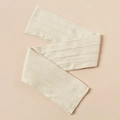 Detailed cable knit texture of a soft cream baby headband in a minimalist flat lay style - Off-White