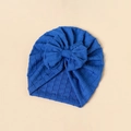 Detailed close-up of blue baby turban hat featuring a textured knit bow and ribbed fabric - Royal Blue