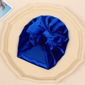 Royal blue velvet baby turban hat with a large bow on an octagonal beige tray - Sapphire Blue