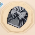 Gray velvet baby turban hat with a large matching bow on a neutral background - Gray