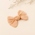 Chic apricot linen bow hair clip for toddlers with soft fabric texture in flat lay style - Apricot