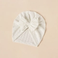 Detailed view of white newborn turban hat with bow and soft textured elastic fabric - White