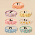 Detailed set of 7 soft nylon baby headbands featuring embroidered lace daisy flowers - One Size / Random Color