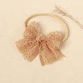 Detail of warm beige lace bow baby headband with soft high elastic nylon band - Caramel color