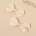 Detail of cream white cotton linen bow hair clips with textured fabric on a natural background - Off White