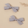 Detail view of handmade linen bow hair clips in light purple-gray set of two - Lavender