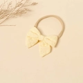 Dettaglio fascia elastica in nylon per neonati con fiocco in tessuto ricamato giallo - Giallo chiaro