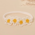 Close-up of soft nylon baby headband with delicate embroidered white daisy flowers - One Size / White
