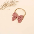 Detail of pink embroidered bow baby headband with soft nylon band and hollow lace texture - Flesh Pink