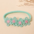 Detailed macro view of mint green nylon baby headband with delicate floral lace embroidery - One Size / Emerald Green