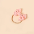 Close-up of baby headband featuring a pink jacquard bow with raised floral textures - Pink Embossed Floral Style