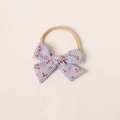 Détail d'un bandeau bébé avec nœud à carreaux lilas et cerises sur nylon souple - Bleu et Violet