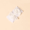 Macro detail of soft nylon baby headband featuring a white daisy print chiffon bow - White