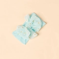 Detail of soft elastic light blue baby headband featuring white daisy prints and a large bow - Light Blue
