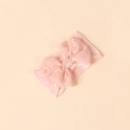 Close-up of pink baby headband featuring white daisy prints and a large bow design - Light Pink
