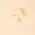 Detail of yellow baby bow headband featuring fresh white daisy print on soft fabric - Light Yellow