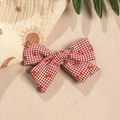 Detailed view of red plaid bow hair clip with cute cherry patterns for children - Red
