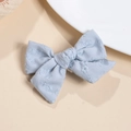 Detail of light blue cotton bow hair clip with fine white flower embroidery and metal grip - Blue