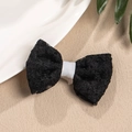 Detail of elegant black lace bow hair clip with white ribbon center and floral texture - Black