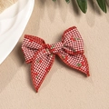 Close-up of red and white plaid bow hair clip with cherry prints and woven texture - Red And White Gingham Style (1)