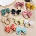 Flache Ansicht von 10 bunten Baby-Stirnbändern mit Gänseblümchen-Muster und Nylon-Gummiband - Zufällig