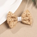 Detailed view of handmade lace bow hair clip with intricate floral embroidery patterns - Caramel color