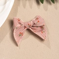 Detail view of a vintage plaid bow hair clip with cute red cherry patterns on beige background - Brown And White Gingham Style (3)