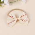 Close-up of baby nylon headband featuring vintage floral embroidery on lace bow - Red Small Flower