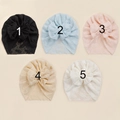 Flat lay of five infant lace bow turbans in black, blue, pink, beige, and cream colors - Random Color
