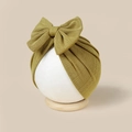 Detail of mustard yellow knitted baby turban hat with a large bow and ribbed texture - Olive Green