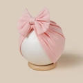 Detail of pink ribbed knit baby turban hat with a soft large bow on a mannequin - Light Pink