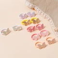 Dettaglio di elastici per capelli a farfalla glitterati per bambine in vari colori - Colore Casuale