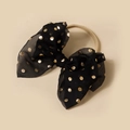 Close-up of black mesh bow with gold polka dots on a soft nylon baby headband - Black