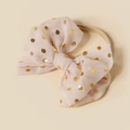 Detail of soft nylon infant headband with sequin gold polka dot bow in light pink - Apricot