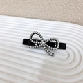 Elegant French style hair clip with white faux pearl bow on a black base - Black